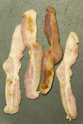 Bacon, sitting on a scratched pan surface