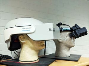 Two 1990s VR headsets on display on mannikin heads