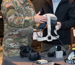 Two men examining US Military IVAS Mixed/Augmented Reality headset prototypes