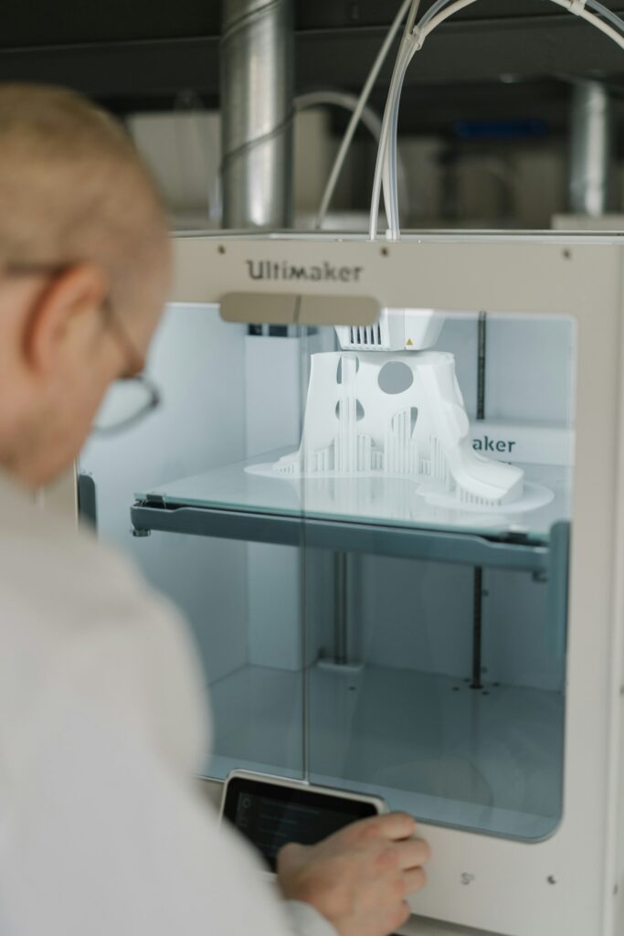Person in a white shirt using a sewing machine in production