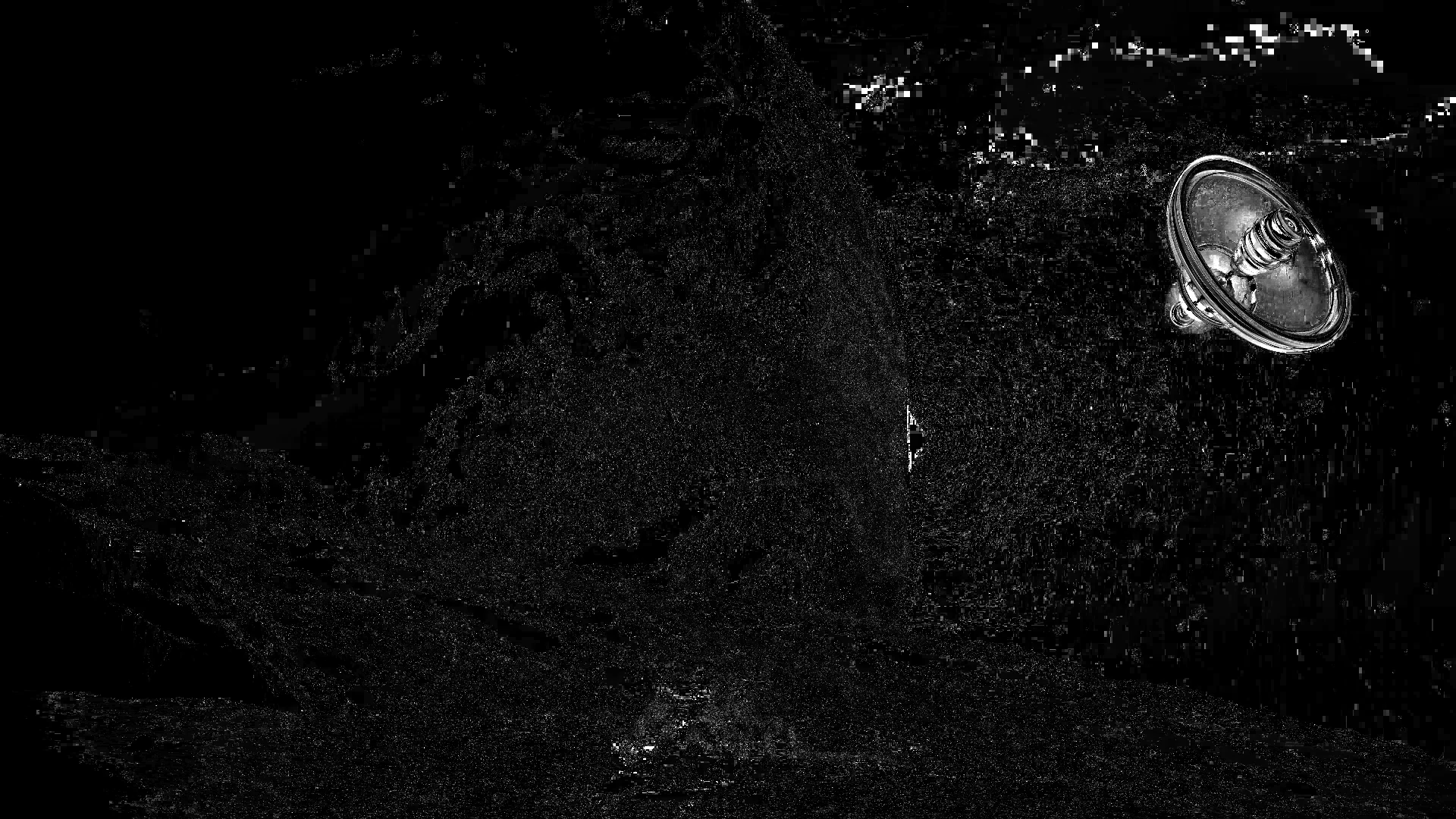 Grayscale motion map of the menu video: the spinning station glows bright, the static sky and planet are mostly dark